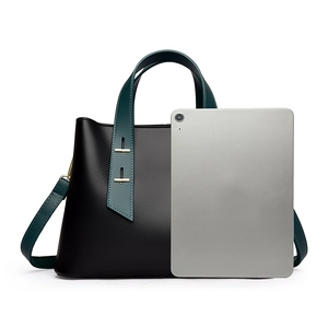 Black pebbled leather tote bag shown with a tablet to demonstrate large storage capacity