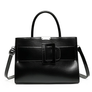 Classic black leather tote bag featuring a large square buckle and top handle for women