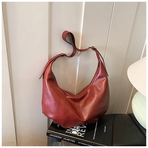 Vue détaillée du sac croissant bordeaux en similicuir texturé avec bandoulière réglable