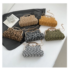 Flat lay of vintage kiss-lock chain bags in leopard print, tweed, and colorful fleece