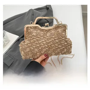 Detail showing plush beige faux fur texture with elegant gold metal handle and retro clasp