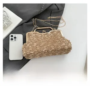 Close-up of leopard pattern evening bag with golden metal frame and chain strap