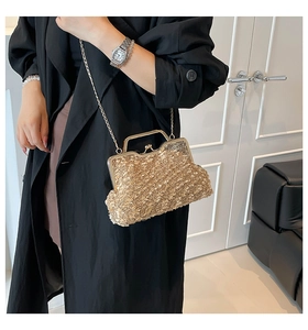 Detailed view of a gold sequin evening clutch bag with metal handle and chain strap