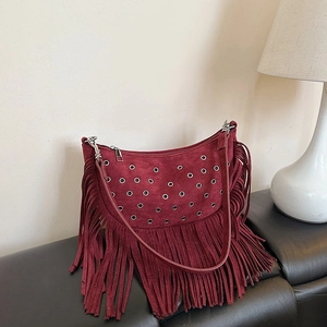 Vintage burgundy faux suede tassel crossbody bag with metallic eyelets and long fringe detail