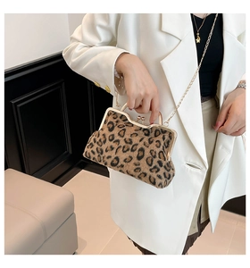 Detail of leopard print faux fur clutch bag with gold ball clasp and chain strap