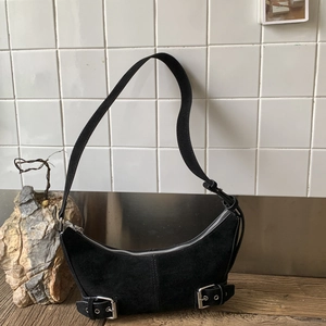 Minimalist black suede crescent crossbody bag with silver hardware and vintage design