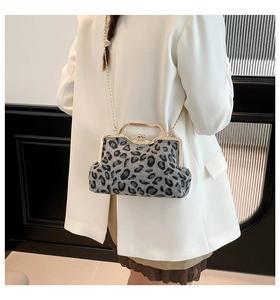 Detail of grey leopard print crossbody bag with gold chain and kiss-lock closure