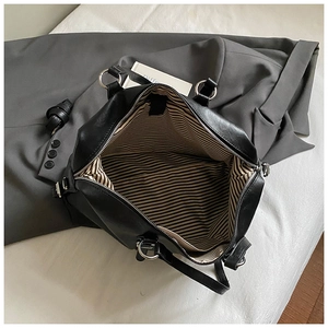Top view of large travel handbag showing striped lining and spacious interior storage