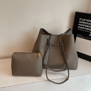 Litchi pattern leather tote set with drawstring closure and inner pouch on marble surface