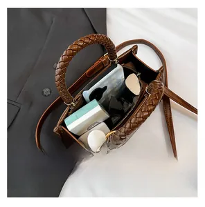 Detail showing the spacious interior of a brown crossbody bag for phone and makeup