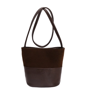 Vintage dark brown suede and leather bucket bag with slim shoulder straps on white background