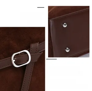 Detail of suede tote bag showing precision stitching, side buckle and base metal studs