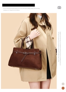 Detail of matte brown tote bag showing smooth suede texture and buckle decoration