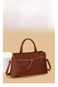 Detail of retro brown suede tote bag showing premium matte texture and leather handle