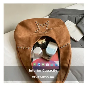 Detailed interior view showing large capacity for tablet and essentials in brown suede hobo bag