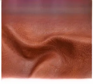 Macro detail of premium brown top-layer cowhide leather showing natural grain and texture