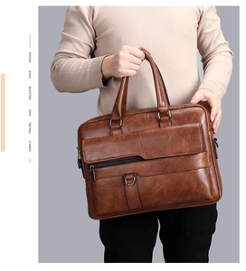 Close-up of brown lychee grain leather business briefcase with zipper pocket details