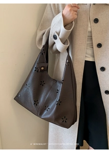Detailed laser-cut flower pattern on dark brown leather hobo shoulder bag