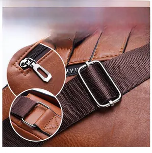 Close-up of polished silver zipper hardware and durable brown leather strap on bag