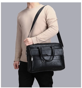 Detailed view of the black textured business briefcase with dual front pockets and straps