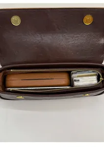 Spacious interior of brown vintage leather bag with magnetic snap and zipper closure