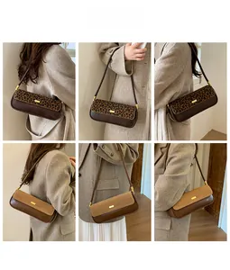 Detail view of leopard print and camel suede shoulder bags with gold buckles