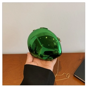 Detailed close-up of metallic green egg-shaped clutch bag with golden chain
