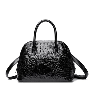 Vintage black faux crocodile shell bag with elegant top handles and adjustable strap