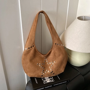 Brown suede shoulder bag with silver star rivets in a stylish retro aesthetic