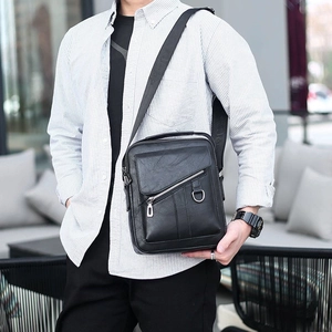 Men's black faux leather crossbody bag with adjustable wide strap and front zipper pocket