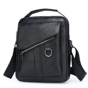 Fashionable black pebbled leather crossbody bag with top handle and metal ring detail