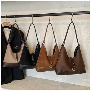 Detail of vintage hobo shoulder bags in suede and leather finish with metal rings