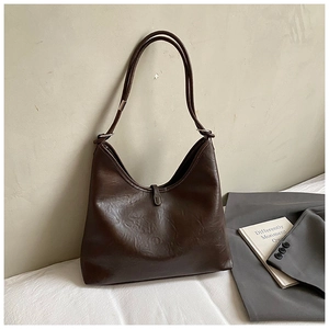 Macro detail of dark brown vintage oil wax leather texture and metal buckle on hobo bag