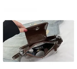 Detail view of the spacious inner compartment of the brown patent leather hobo bag