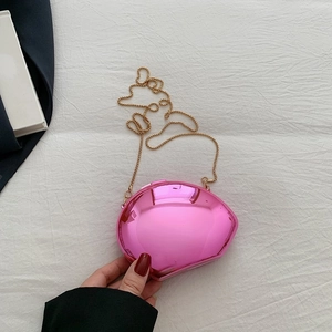 Pink shell-shaped mini evening bag with glossy finish and gold chain strap