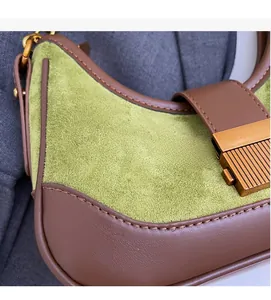 Close-up of green suede and brown leather patchwork with vintage gold metal buckle