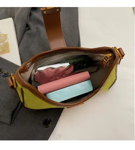 Detail view of the green suede bag interior with large capacity and inner zipper pocket
