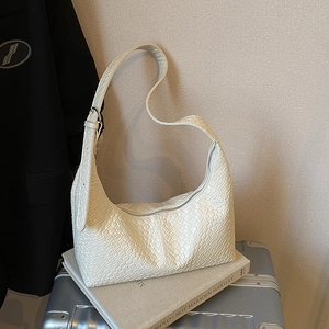 Retro woven beige hobo shoulder bag with adjustable strap on minimalist background