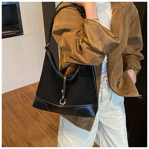 Close-up of black hobo bag with contrast stitching and silver metal ring detail