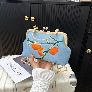 Light blue embroidered crossbody bag with persimmon pattern and gold metal clasp handle