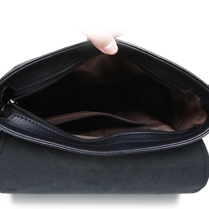 Internal view of black leather shoulder bag with brown fabric lining and inner zipper pocket