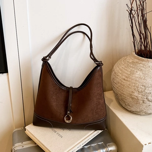 Retro dark brown hobo shoulder bag with metal ring detail on vintage suitcase
