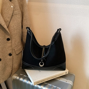 Minimalist black canvas tote bag with white stitching and metal ring buckle detail