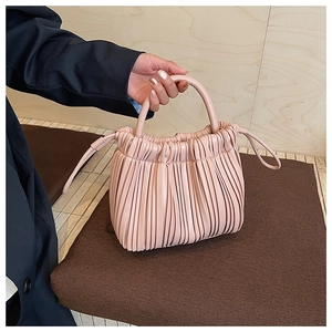 Detail showing soft pleated texture and sleek leather drawstring on the pink cloud bag