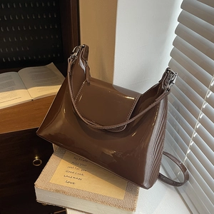 Deep brown patent leather shoulder bag with glossy finish and silver hardware details