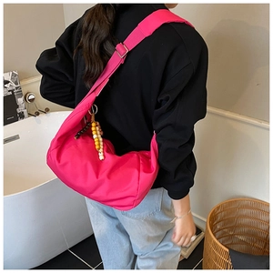 Borsa a tracolla a mezzaluna in nylon fucsia con perline colorate su tracolla larga