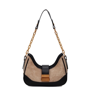 Fashionable beige faux suede crescent bag with black leather trim and gold chain strap