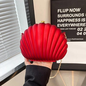 Deep red shell-shaped acrylic evening clutch bag with golden chain and matte texture