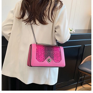 Detail of pink-purple gradient snakeskin embossed bag with dark metal chain and clasp