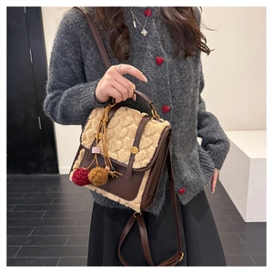 Detail of vintage heart-patterned backpack in brown leather and beige faux fur